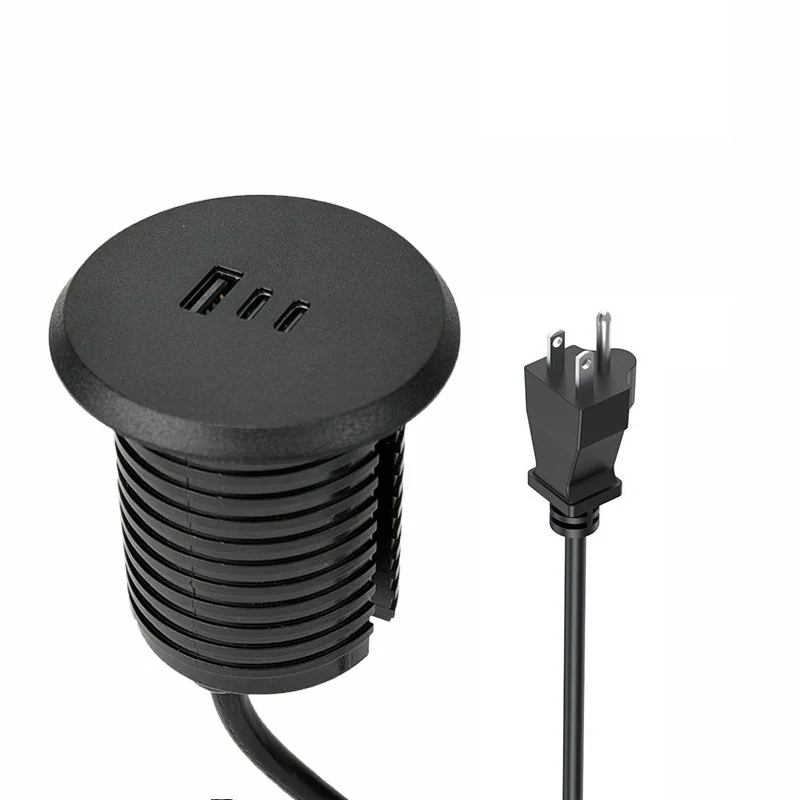 Round recessed desk power module shown with cable and plug