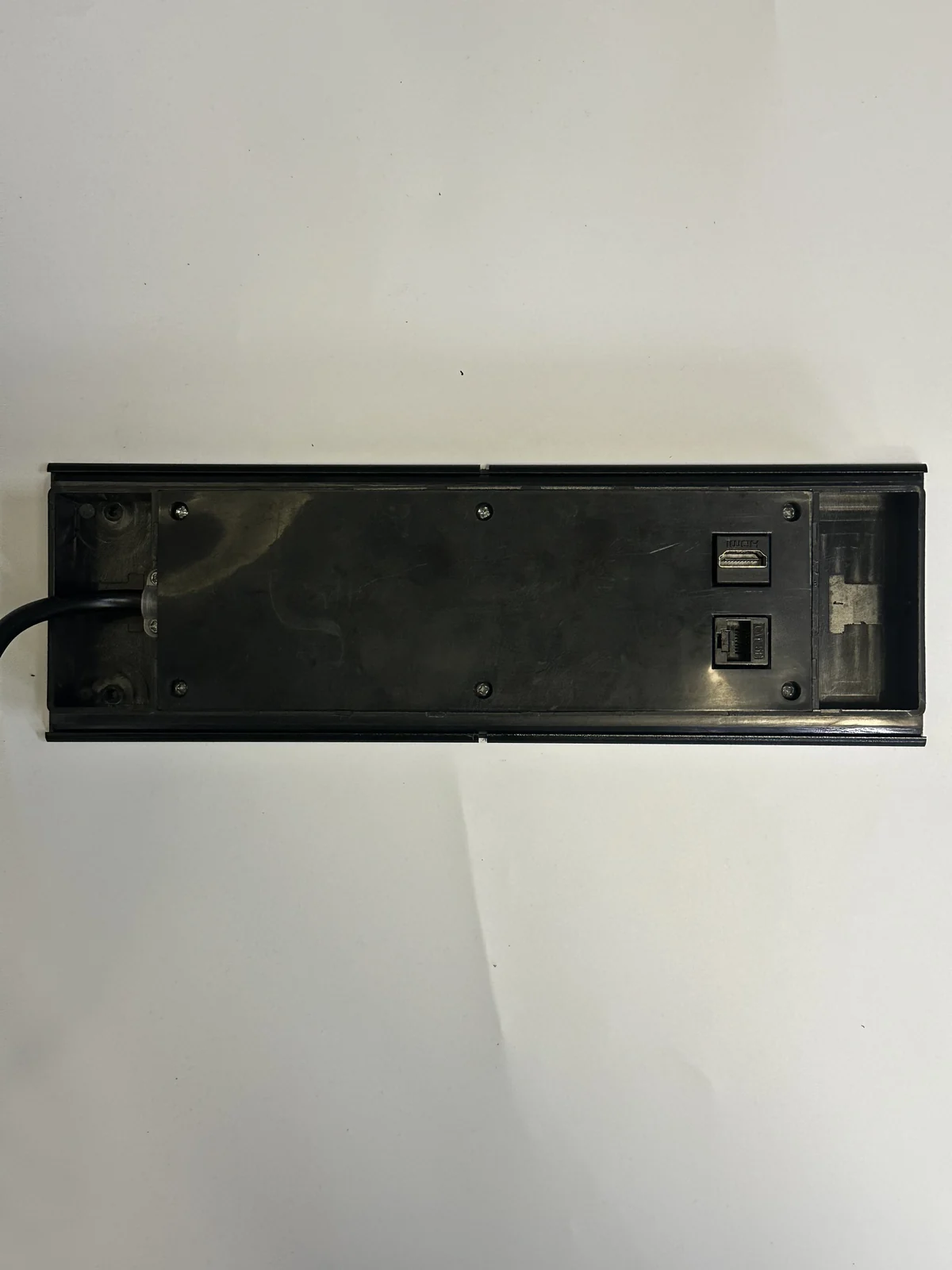 Rear view of a sliding-cover recessed desk power module